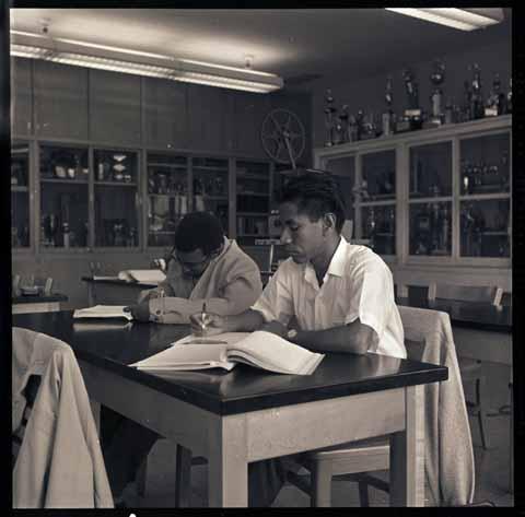 [Two students working at a lab desk]