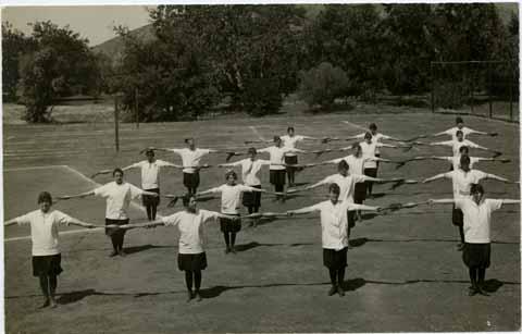 Women students performing 'gymnasium drill' with 'clubs'
