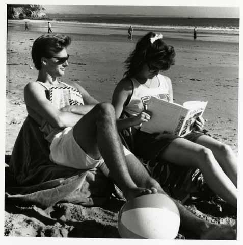 Students reading textbooks at the beach