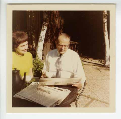 Mr. and Mrs. Kennedy sitting at a table reading the newspaper