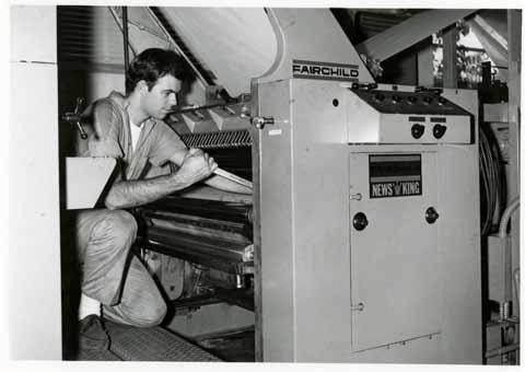 Printing student repairing a Fairchild News King press