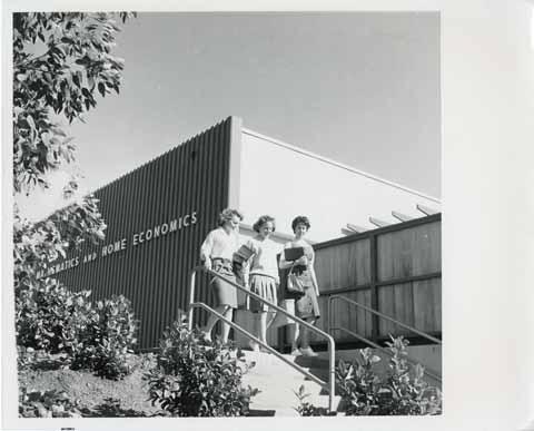 [Three women students outside the Math and Home Economics building]