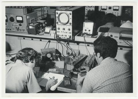 [Electrical Engineering students in lab using an oscilloscope]