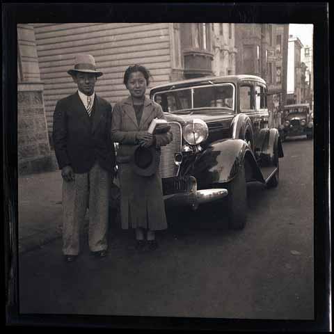 [Fred Louis and unidentified woman in front of an automobile]
